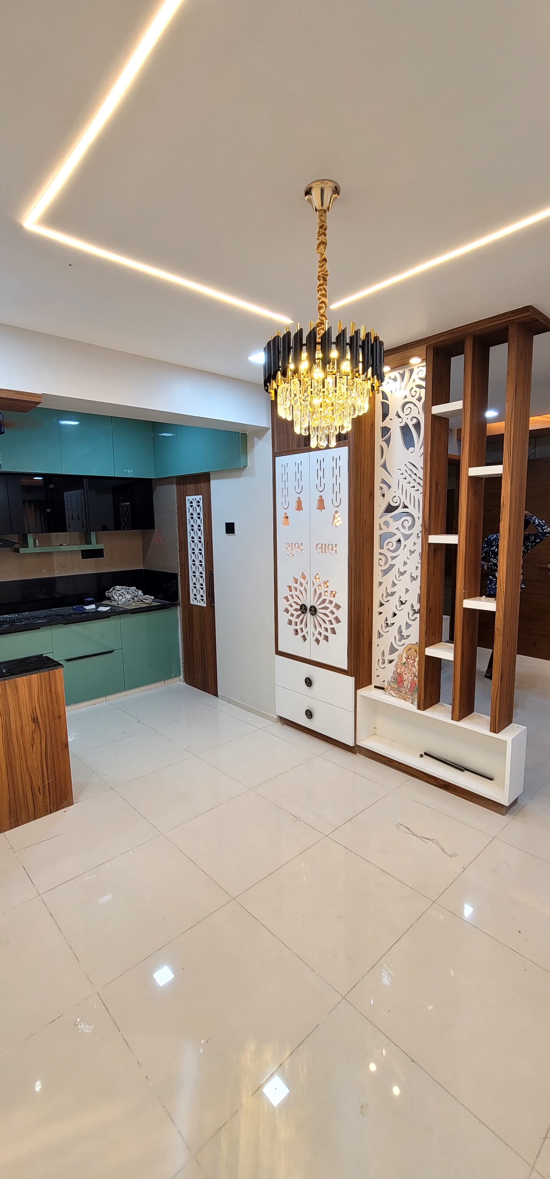 A bespoke RAVYA PVC temple and pooja unit with a lit deity niche.