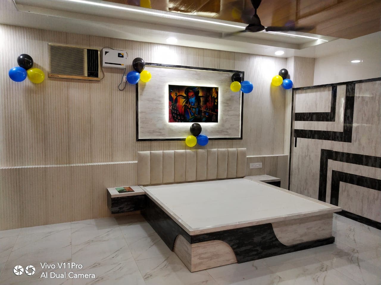 Bedroom with fluted wall panels, custom bed and geometric wardrobe.