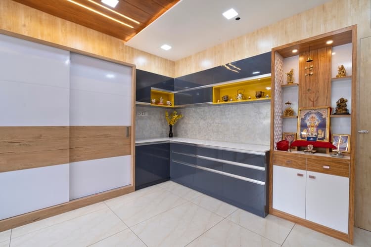 Built-in wood-look PVC pooja unit beside sliding wardrobe storage.