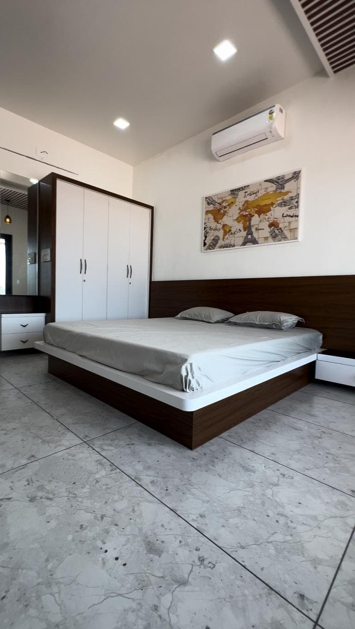 Minimal bedroom with platform bed and white framed wardrobe.