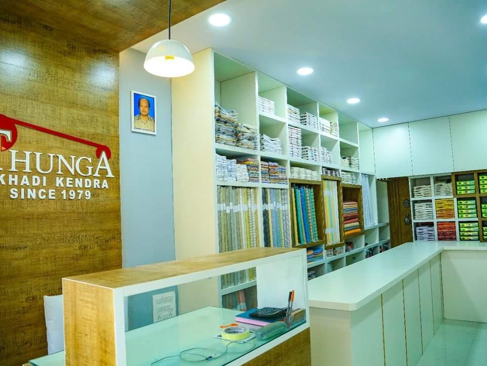 Retail interior with wood-grain wall panels and custom white shelving.