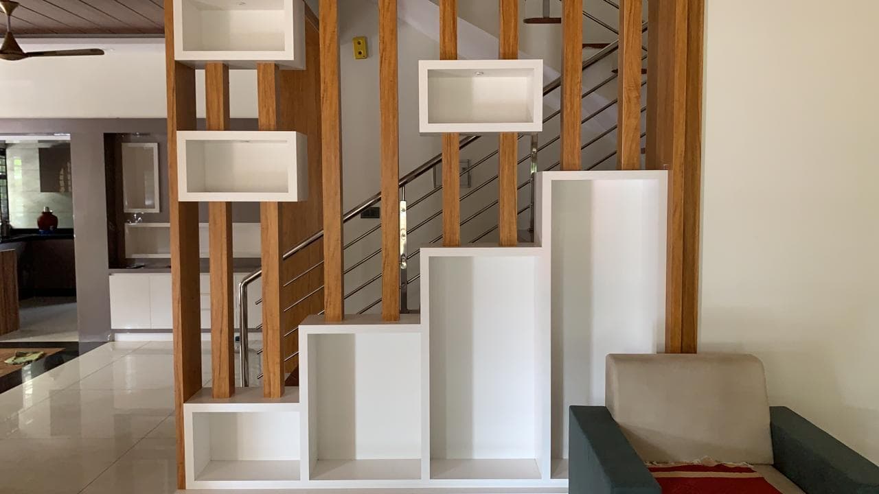 Vertical wood-slat partition with white shadow-box shelves.