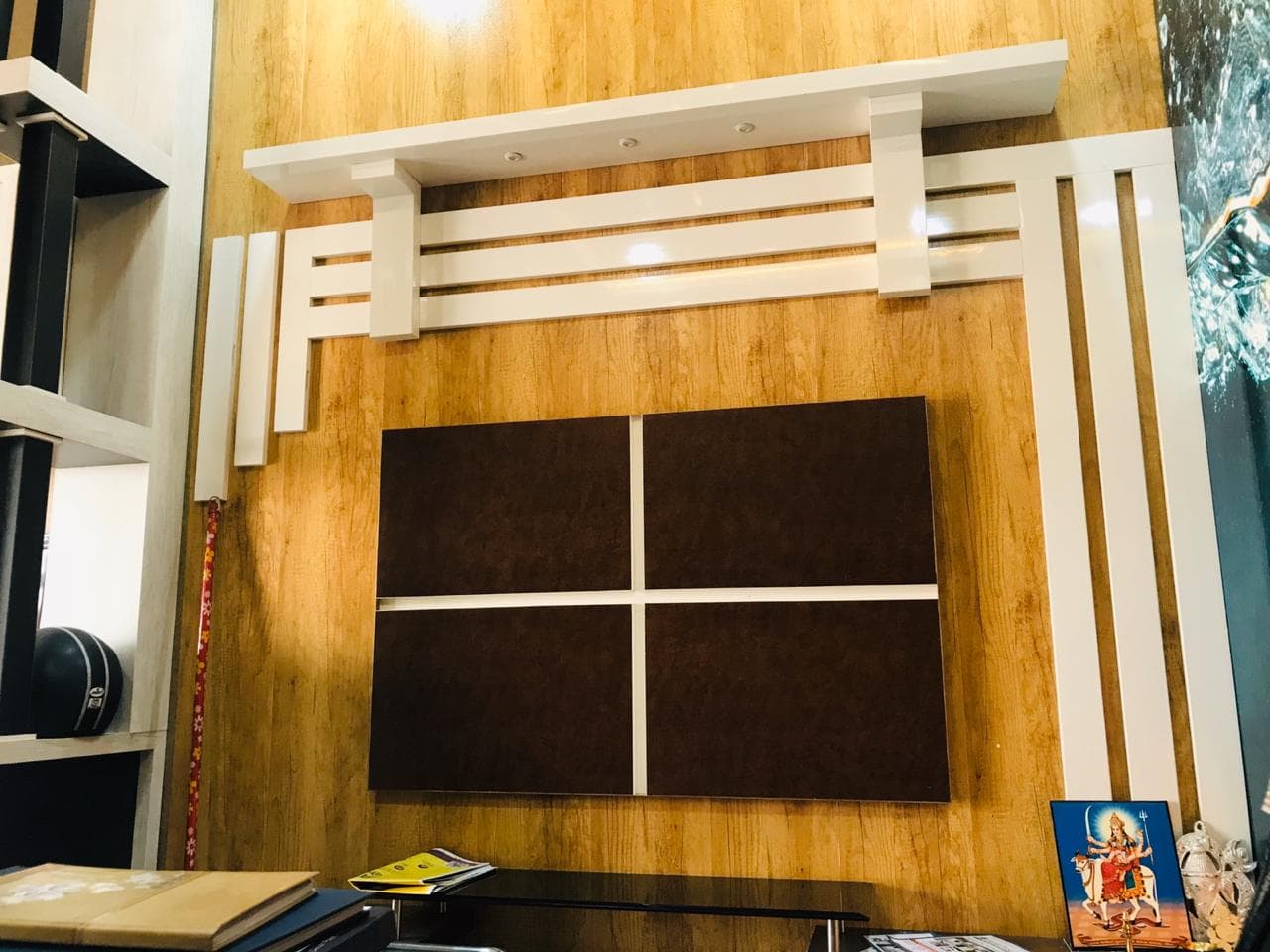 Wood-panel feature wall with geometric white accents.