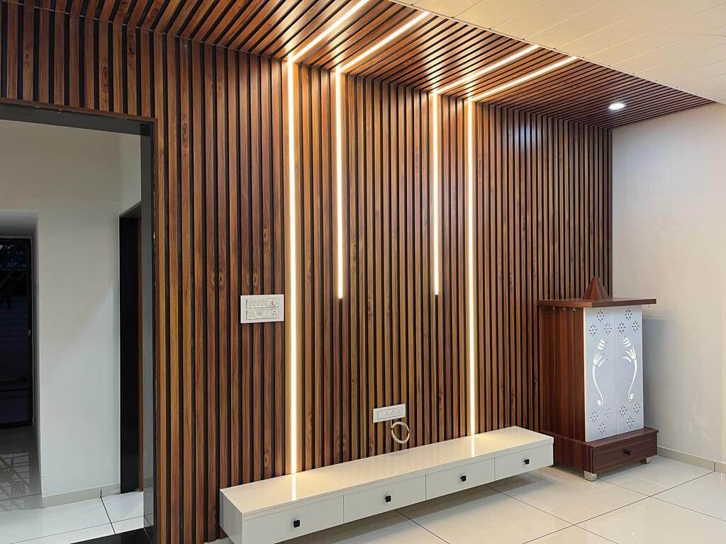 Wood-slat wall and ceiling wrap with integrated LED strips and floating console.