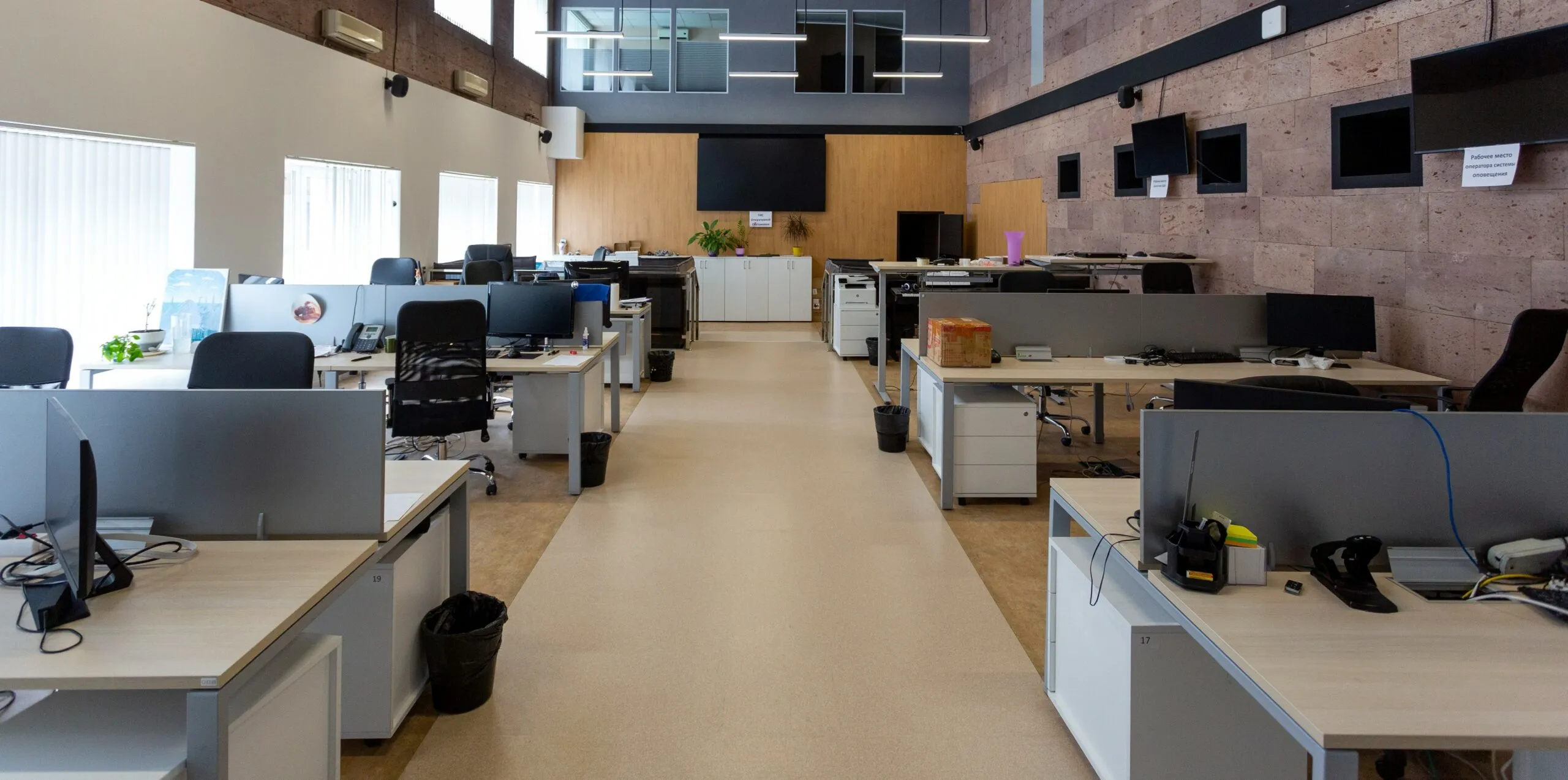 An open office space with modular workstations, timber accents and natural light.