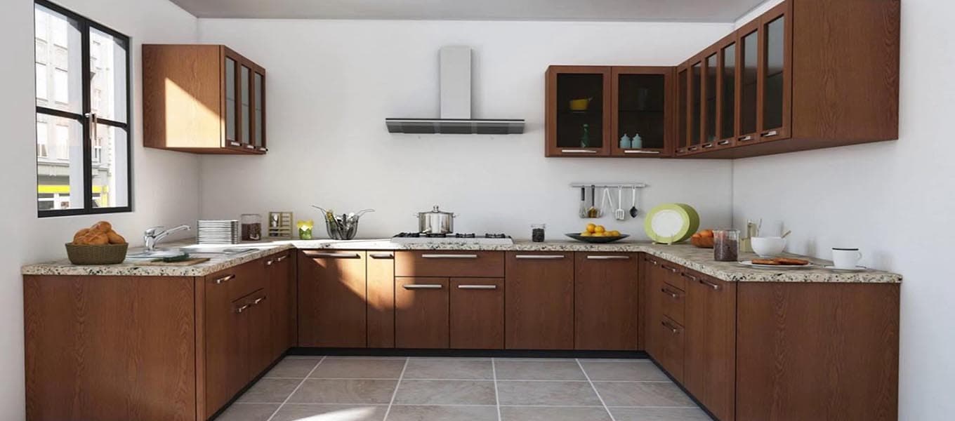 Open RAVYA kitchen layout with a breakfast counter and integrated storage.