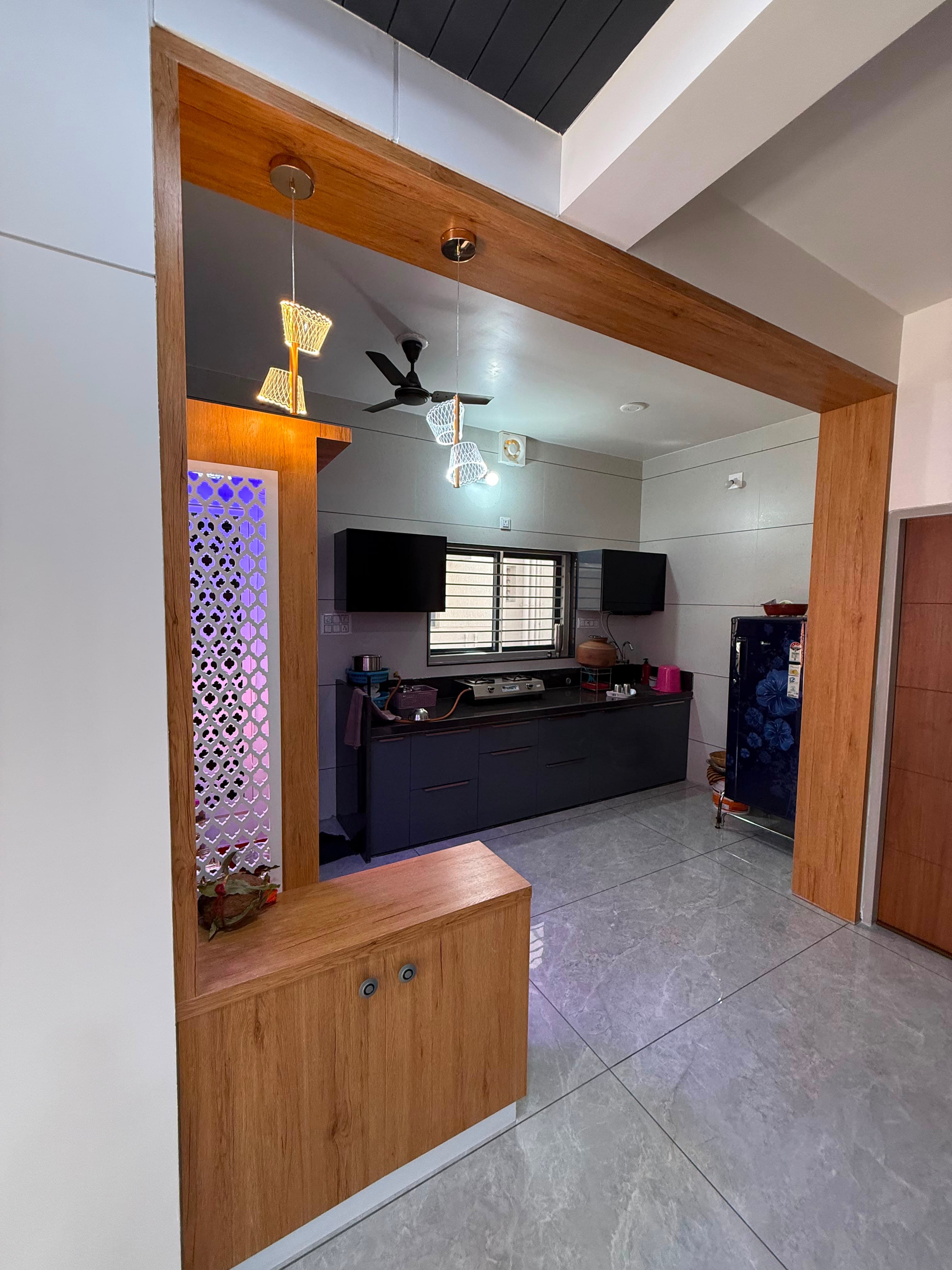 Full elevation of a RAVYA modular PVC kitchen with wall and base cabinets.