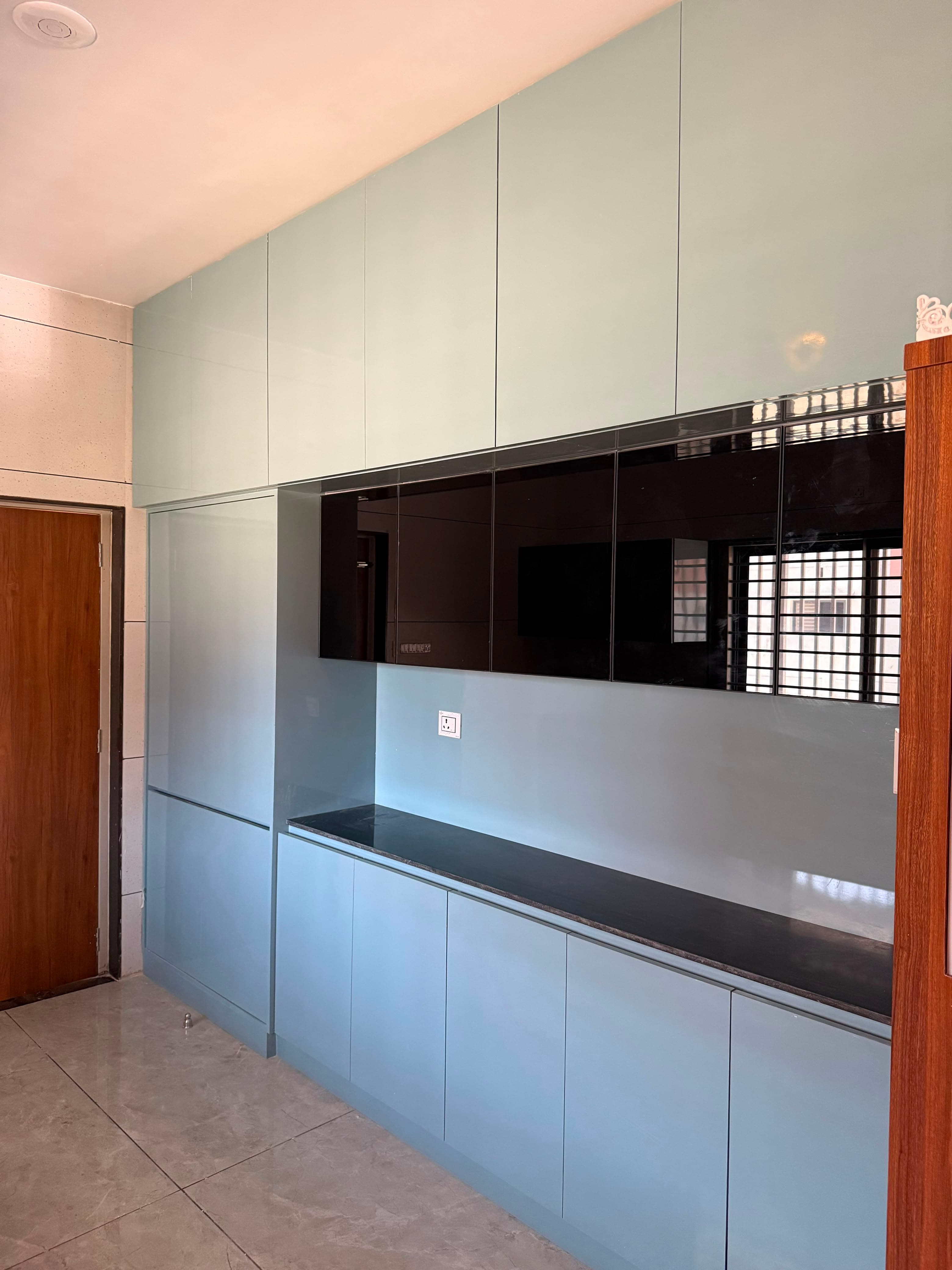 RAVYA kitchen island with cabinetry and considered task lighting.