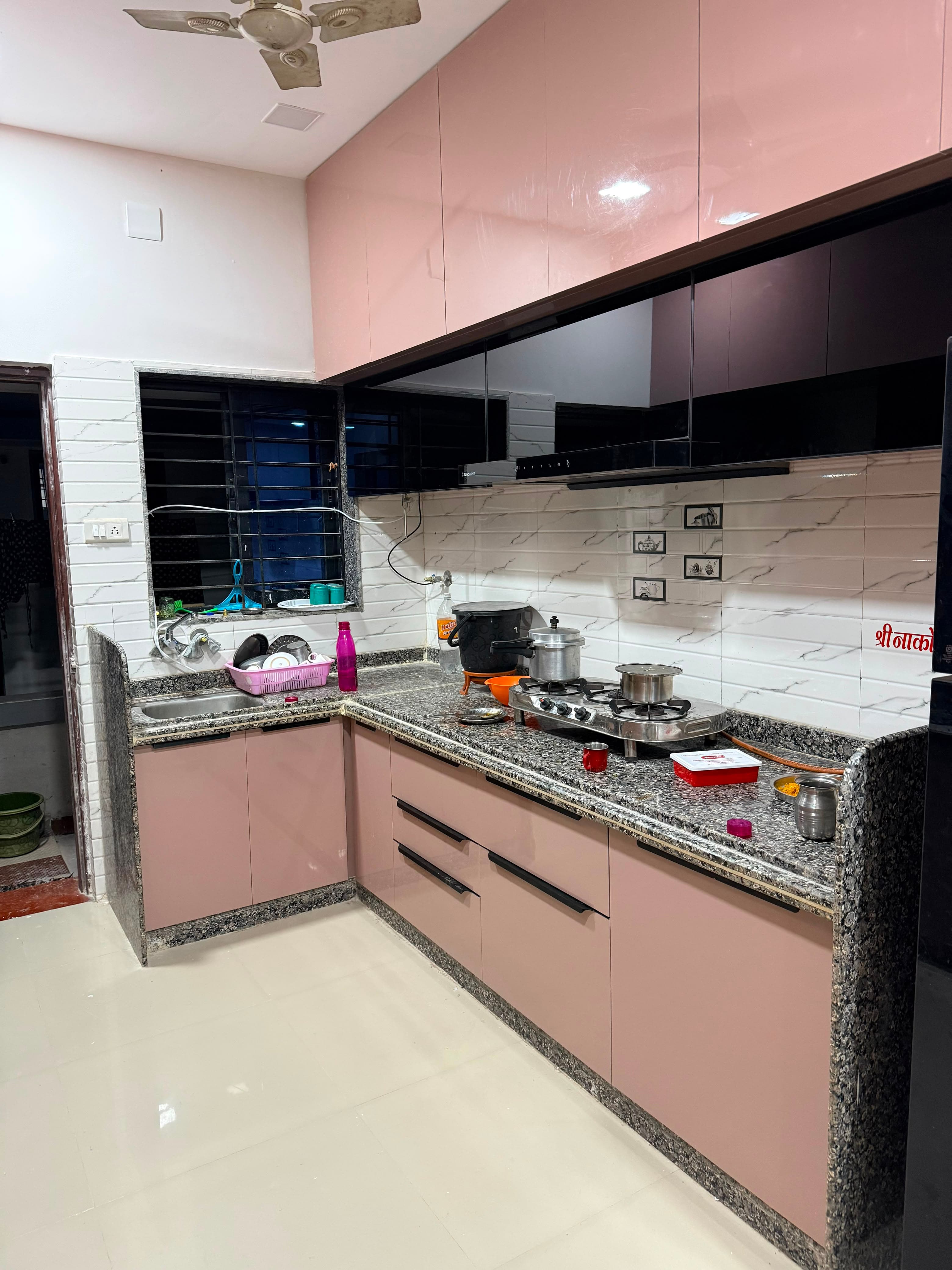A bespoke RAVYA PVC kitchen installed with wall units and a tall larder.