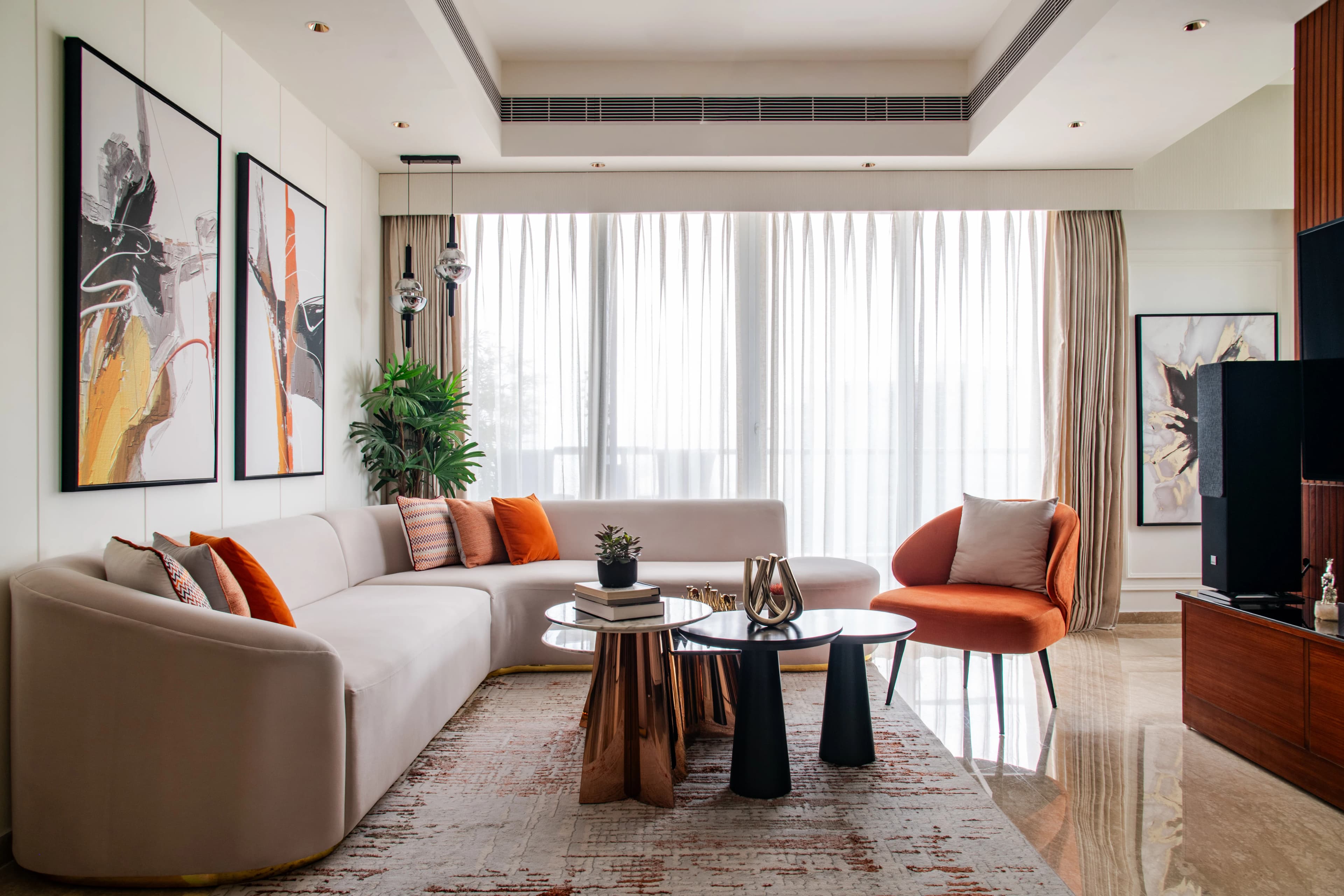 Expansive RAVYA living interior with a full-width media and display wall.
