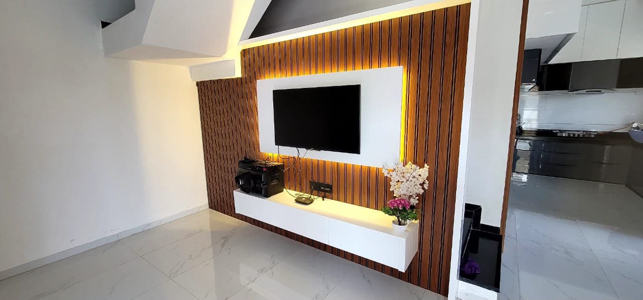 Open RAVYA living composition with a low console and display units.