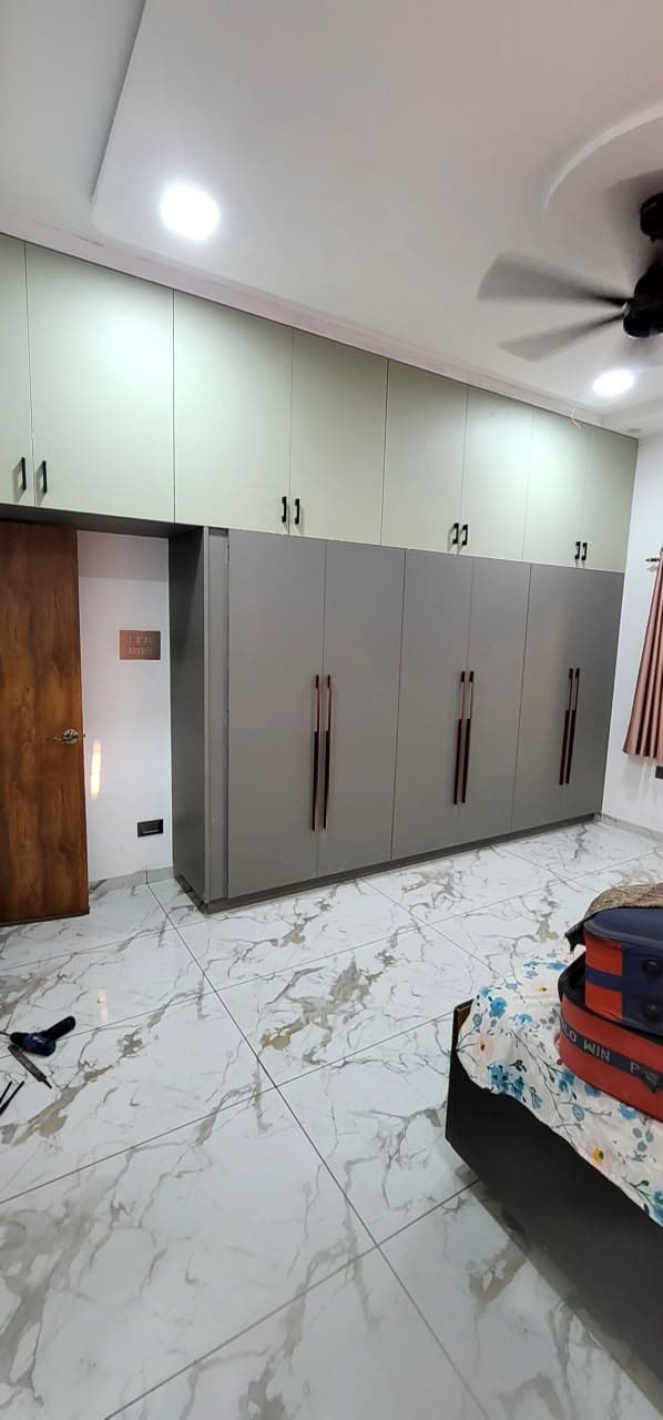Refined RAVYA wardrobe front detailing with slim handles.