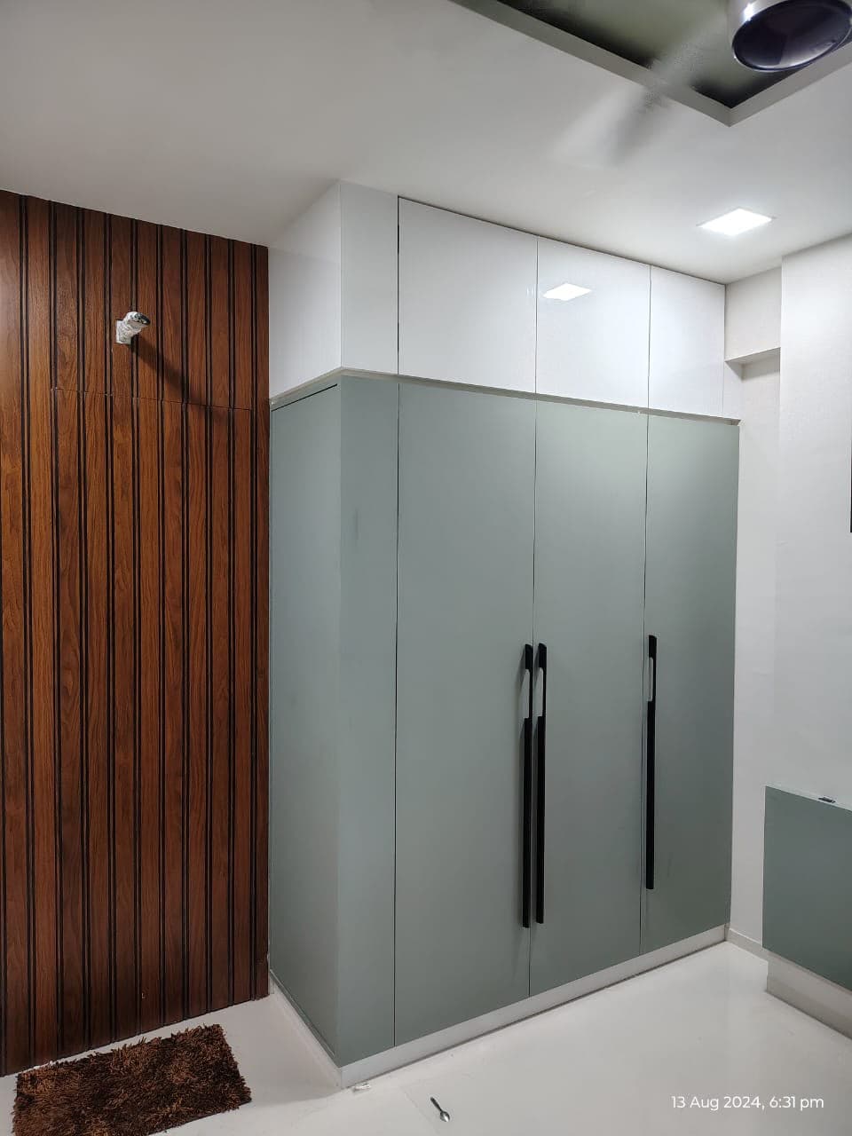 RAVYA sliding wardrobe detail with a mirrored panel.