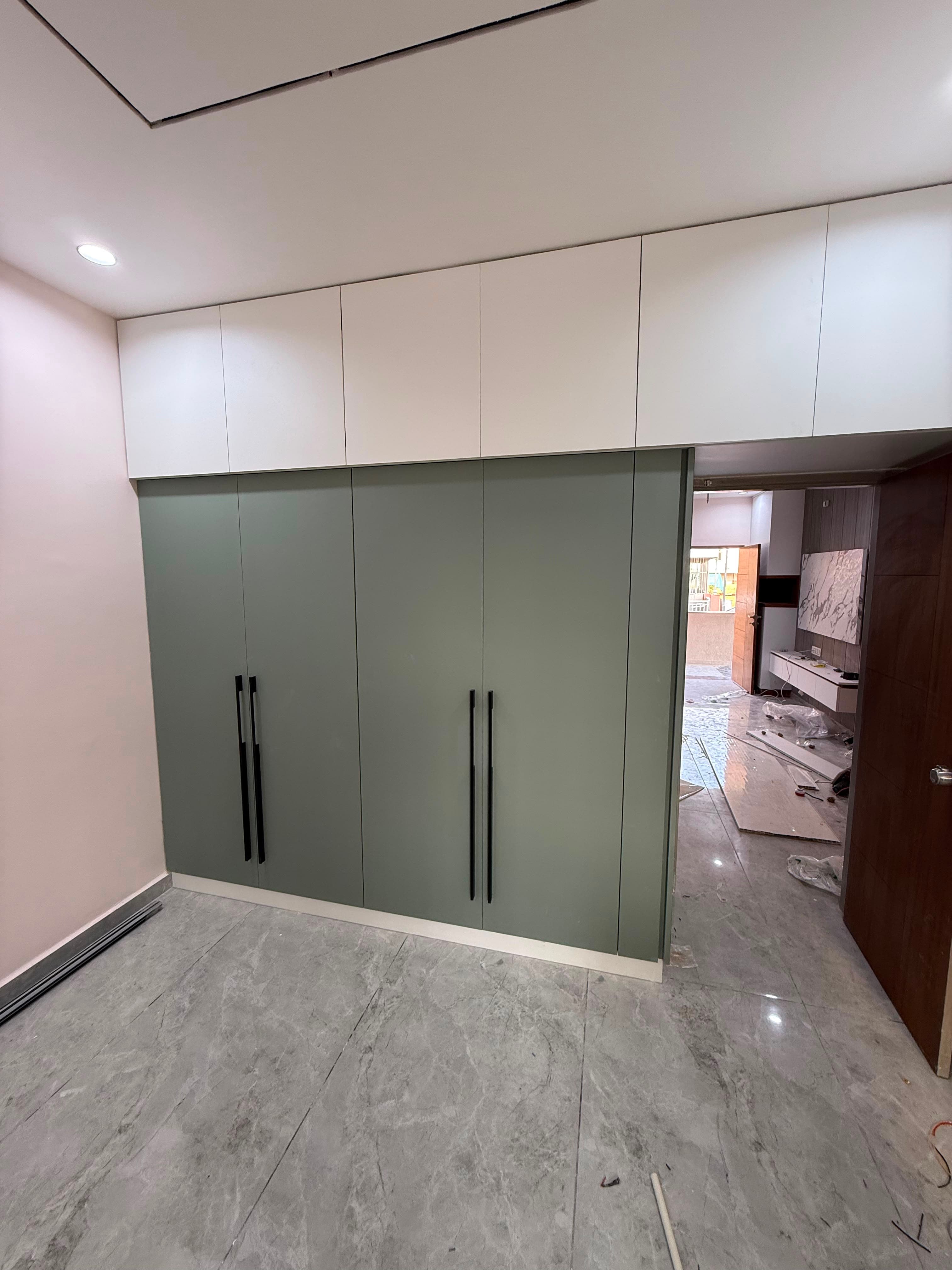 Custom RAVYA wardrobe elevation with a matte PVC finish.