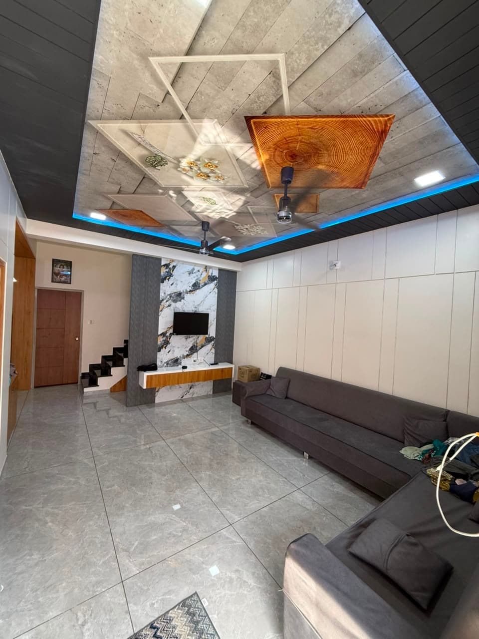 RAVYA living room with a composed media wall and display niches.