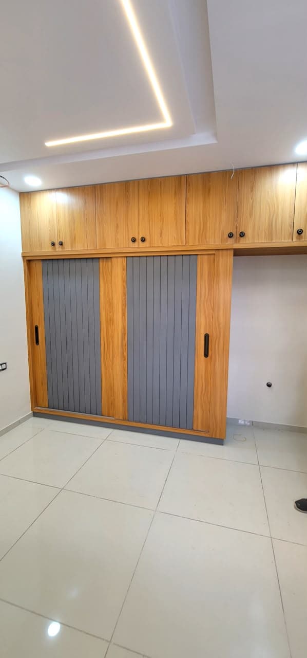 Bespoke RAVYA PVC wardrobe elevation with sliding fronts.